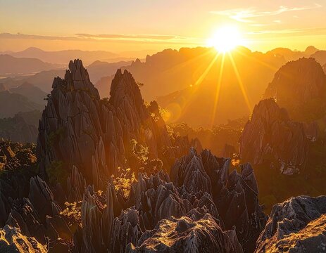 Dramatic jagged mountain peaks illuminated by a golden sunrise.