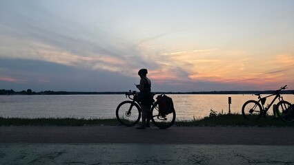 Fototapeta premium silhouette of a man riding a bike