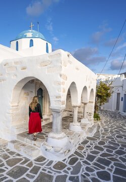 Tourist with red dress, Blue and White Greek Orthodox Church Agios Nikolaos, Parikia, Paros, Cyclades, Aegean Sea, Greece