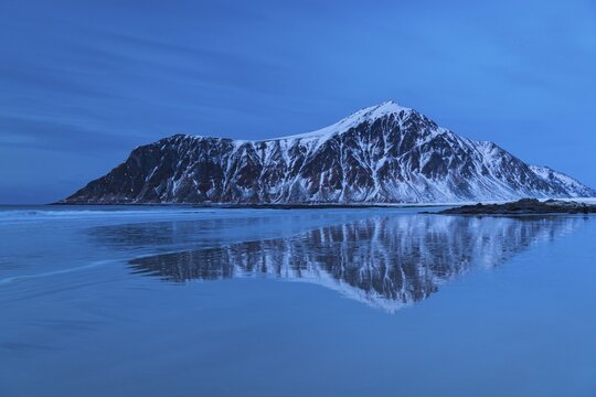 Winter Scandinavian landscape, sea, mountains, snow, blue hour, Flakstad, Nordland, Lofoten, Norway