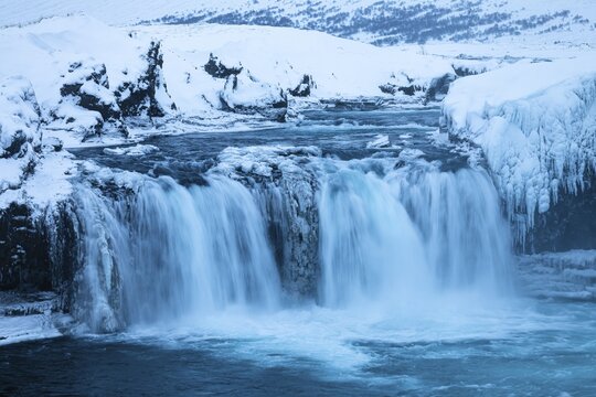 Godafoss waterfall, icy and snowy rock face, snowy landscape, Northern Iceland Eyestra, Iceland