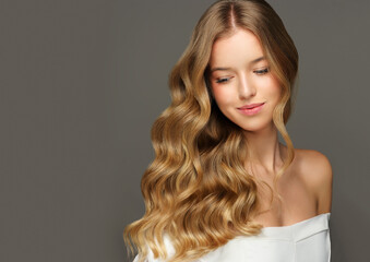 Beauty blonde girl with long and shiny wavy Hair ,coloring and toning, shatush and balayash . Beautiful woman model with curly hairstyle  © Sofia Zhuravetc