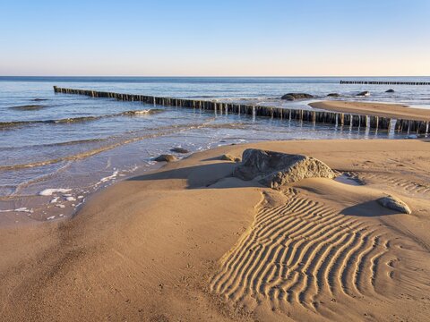 Pristine beach on the Baltic Sea with groynes and sand ripples, Baltic resort K&uuml;hlungsborn, Mecklenburg-Western Pomerania, Germany