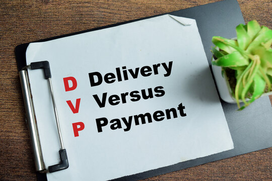 Concept of DVP - Delivery Versus Payment write on clipboard isolated on Wooden Table.