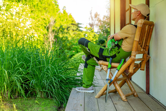 Relaxing on a porch while taking a break from gardening in a green area