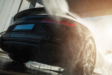 Plakat Car being washed in a clean car wash during the afternoon sun