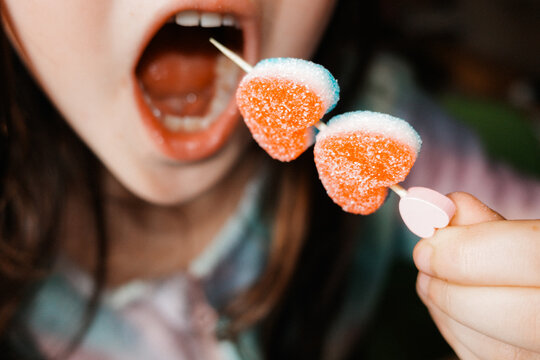 Young Child Enjoying Gummy Candy heart 