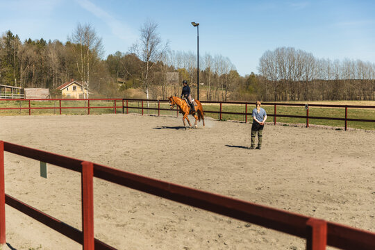 Equestrian Training with Coach in Arena