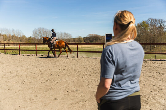 Coach Recording Horse Rider on Smartphone