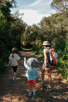 Grandmother and kids Walk Along Mediterranean landscape