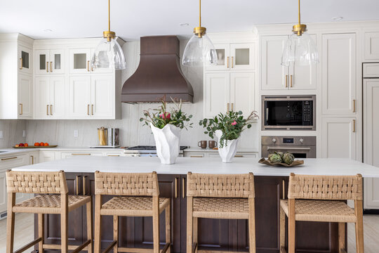 Bright Modern White Kitchen with Large Island and Woven Bar Stools