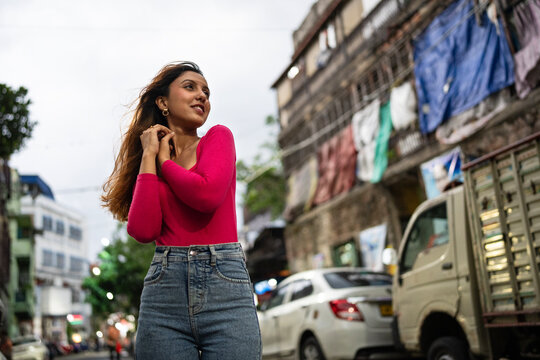Young Indian woman enjoying dazzling in the city at outdoors