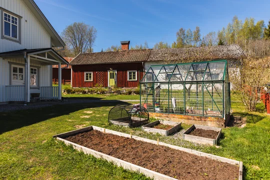Sustainable Garden with Greenhouse and Raised Beds