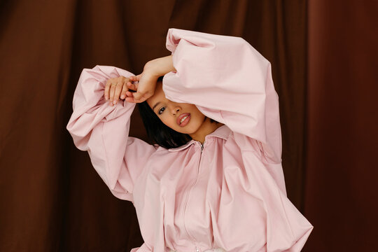 Woman in stylish puffy pink jacket