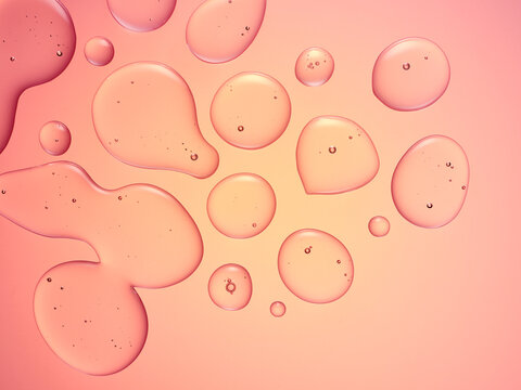 Oil bubbles against a pink / peach background 