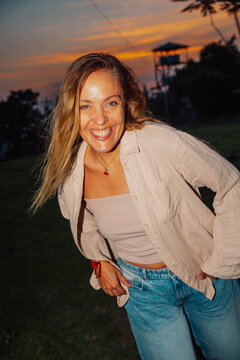 Smiling Woman Poses During Sunset in Outdoor Setting