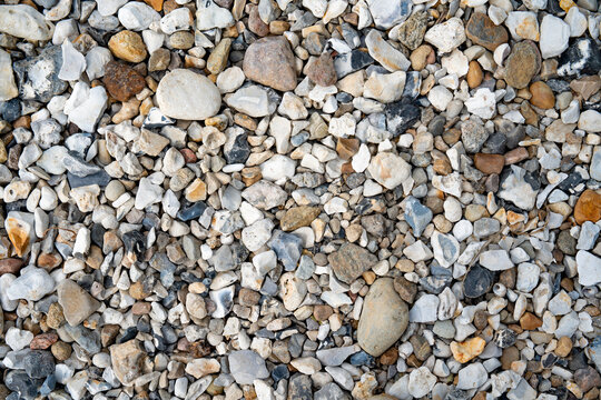 Danish east coast with numerous pebbles on beach in top-view. Maritime background for vacation and tourism.