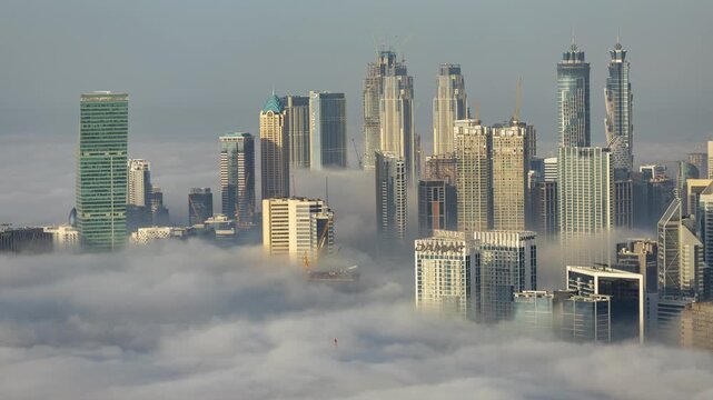 dubai with mist of clouds below the skyline from a high vantage point 
