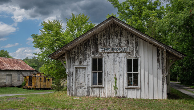 Abandoned buildings and railroad caboose at the historical Cohasset Depot in rural Virginia.