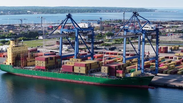 Aerial view of container ship and port cranes in Copenhagen city, Denmark