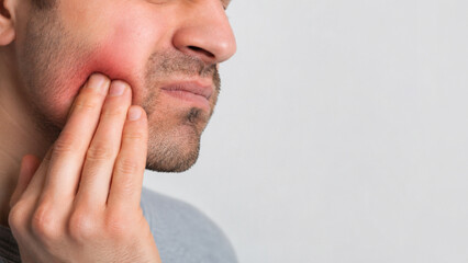 Naklejka premium Man Experiencing Tooth Pain and Dental Discomfort