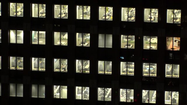 TOKYO, JAPAN : Close up shot of office building window at night. Job, work, company, corporate and business people concept time lapse video.