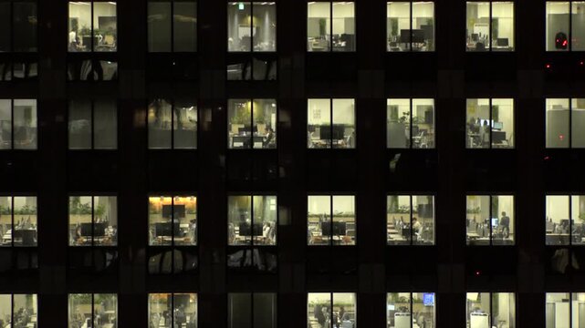 TOKYO, JAPAN : Close up shot of office building window at night. Job, work, company, corporate and business people concept time lapse video.