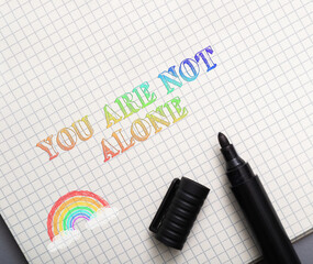 Fototapeta premium Rainbow Text Message of Support on Grid Paper