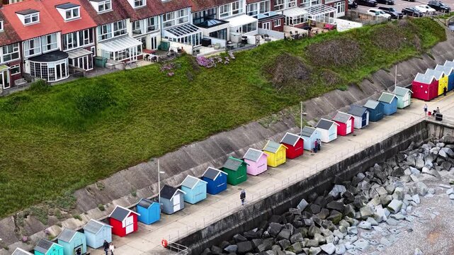 Aerial view of colorful beach huts on promenade, Sheringham town, Norfolk, UK
