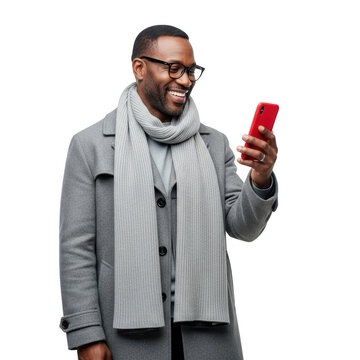 Smiling man wearing a scarf and glasses looks at his red smartphone with a