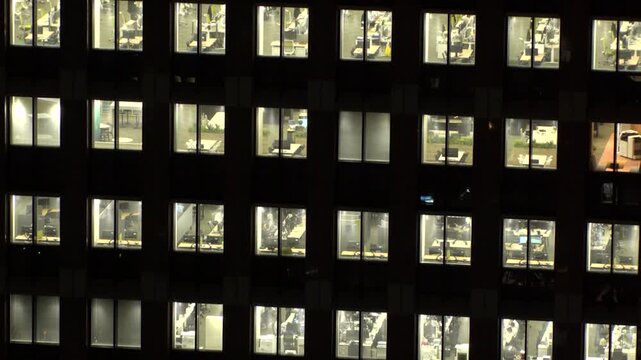 TOKYO, JAPAN : Close up shot of office building window at night. Job, work, company, corporate and business people concept time lapse video.