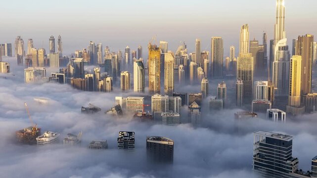 dubai with mist of clouds below the skyline from a high vantage point 