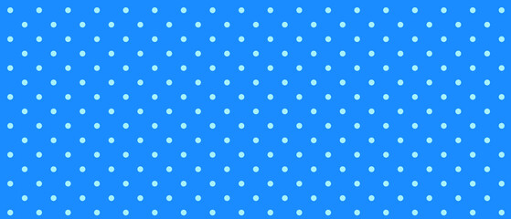 Blue polka dot pattern on a light background with copy space © Natalia