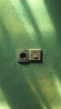 Vintage Power Socket and Light Switch with Sunlight Shadows.