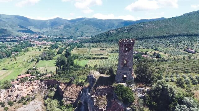Aerial view of medieval tower on the top of the mountain. Drone viewpoint. Slow motion