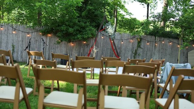 Outdoor wedding ceremony setup in backyard garden
