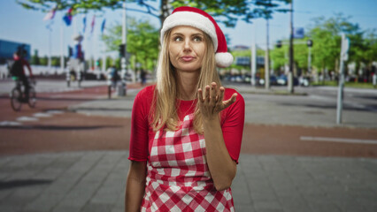 Fototapeta premium Woman in santa hat and checkered apron, hand to mouth for yawn while standing on busy street with cyclists; tired holiday moment.