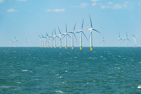 Rows of offshore wind turbines of the Burbo Bank windfarm in the Irish Sea near the UK coast between Heysham and the Isle of Man.