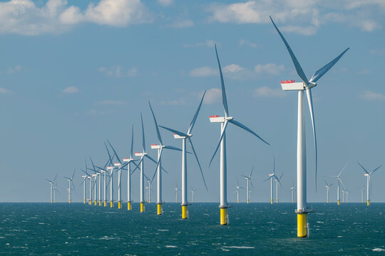 Rows of offshore wind turbines of the Burbo Bank windfarm in the Irish Sea near the UK coast between Heysham and the Isle of Man.