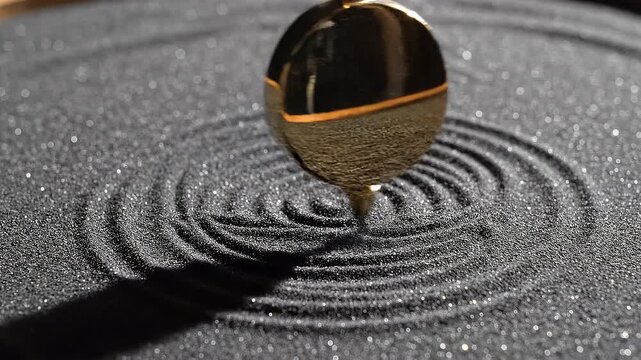 Golden Spinner Creating Waves in Black Sand Surface
