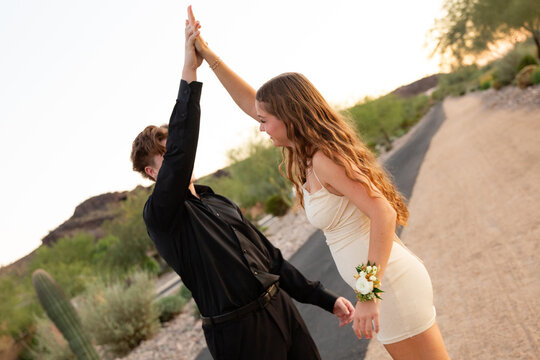 dressed up couple dancing outside