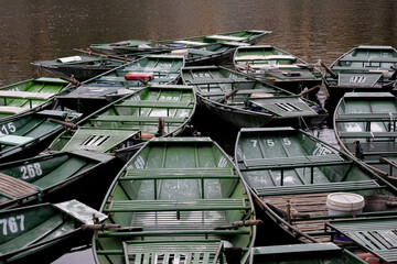 Wooden rowing boats on Ngo Dong River in Tam Coc, Ninh Binh, Vietnam  © BelénMenta