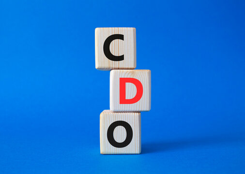 CDO - Collateralized Debt Obligation symbol. Wooden cubes with word CDO. Beautiful blue background. Business and Collateralized Debt Obligation concept. Copy space.