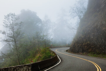 Fototapeta premium Misty Cliffside Road Toward Unknown Places