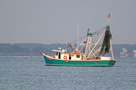 Magwood's Pride, a wooden fishing trawler built in 1958, sails out of Charleston Harbor, SC, USA on June 25, 2026.
