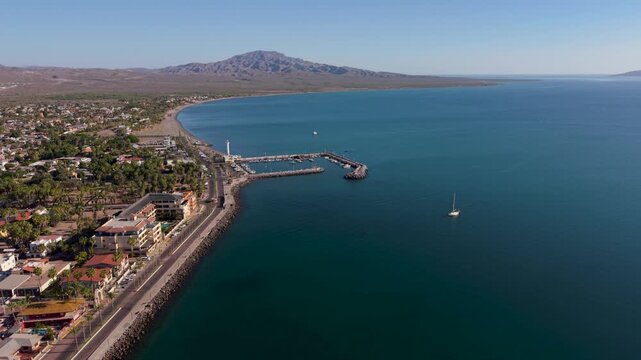 Aerial views show the sunrise over the harbor and malecon in Loreto, Baja California Sur, Mexico, highlighting the beautiful waterfront.