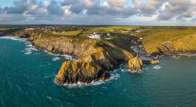 Aerial view from the sea of the Cornish fishing village of Mullion Cove and its historic harbour