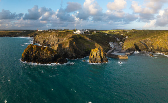 Aerial view from the sea of the Cornish fishing village of Mullion Cove and its historic harbour