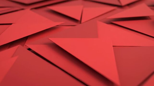 A 3D geometric pattern of red triangular shapes on a white background