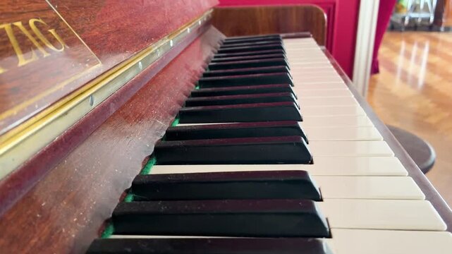 Macro detail of an elegant old piano keyboard, black and white, ready for a musical performance